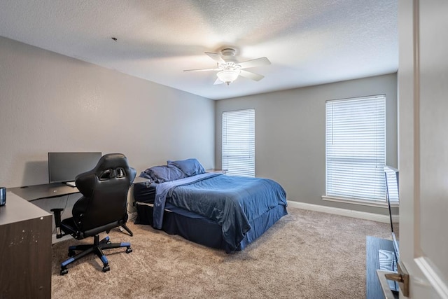 4508 Island Dr, Midland, TX 79707 - bedroom featuring carpet floors, a textured ceiling, an office area, ceiling fan, and baseboards