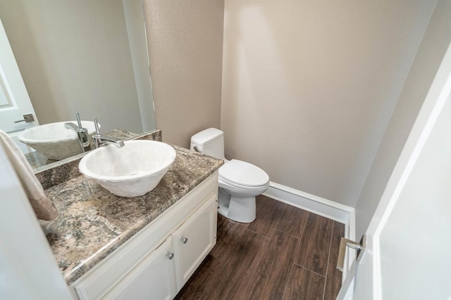 4508 Island Dr, Midland, TX 79707 - bathroom with vanity, toilet, wood finished floors, and baseboards