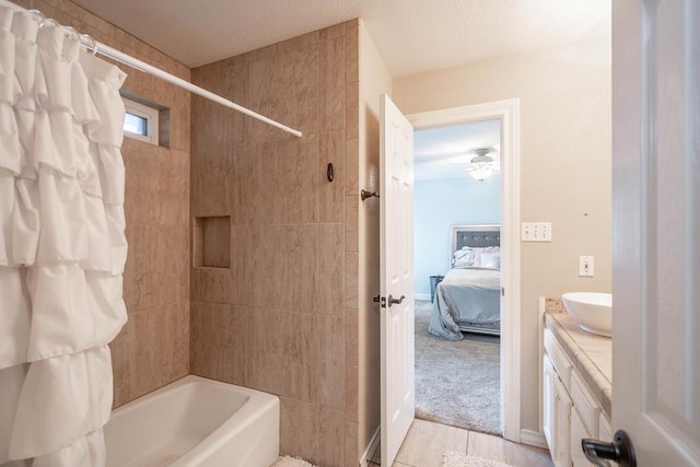 4508 Island Dr, Midland, TX 79707 - ensuite bathroom with shower / tub combo, vanity, a textured ceiling, a ceiling fan, and tile patterned floors