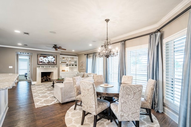 4508 Island Dr, Midland, TX 79707 - dining area featuring crown molding, a fireplace, a chandelier, dark wood-style flooring, and a ceiling fan