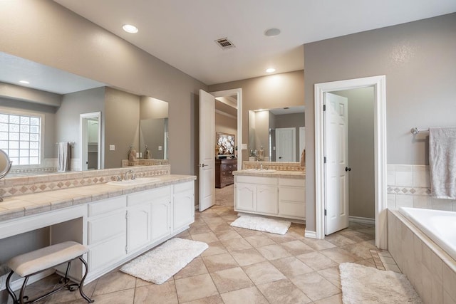 4508 Island Dr, Midland, TX 79707 - bathroom with a garden tub, vanity, recessed lighting, and baseboards