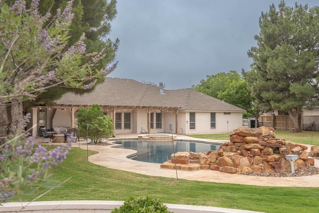 4508 Island Dr, Midland, TX 79707 - back of property with a pergola, a patio area, and a pool with connected hot tub