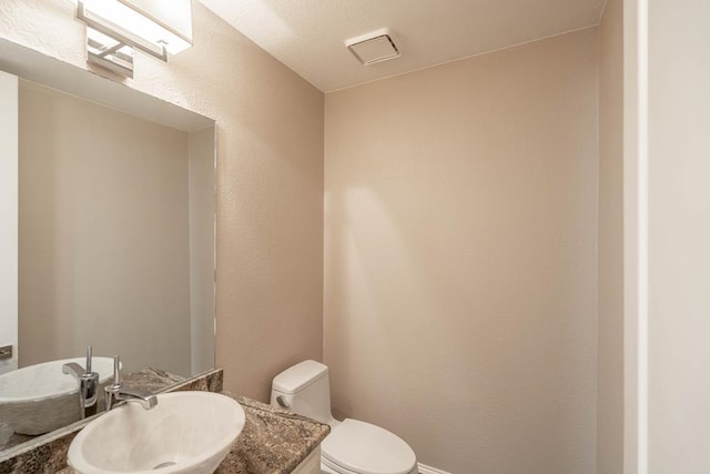 4508 Island Dr, Midland, TX 79707 - bathroom featuring toilet, baseboards, and vanity