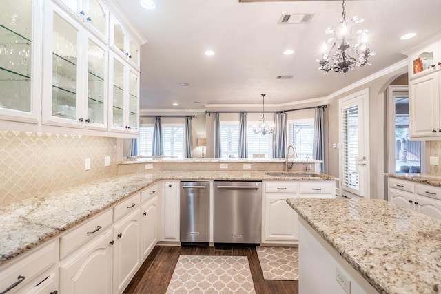 4508 Island Dr, Midland, TX 79707 - kitchen with stainless steel dishwasher, a sink, a chandelier, dark wood finished floors, and a peninsula