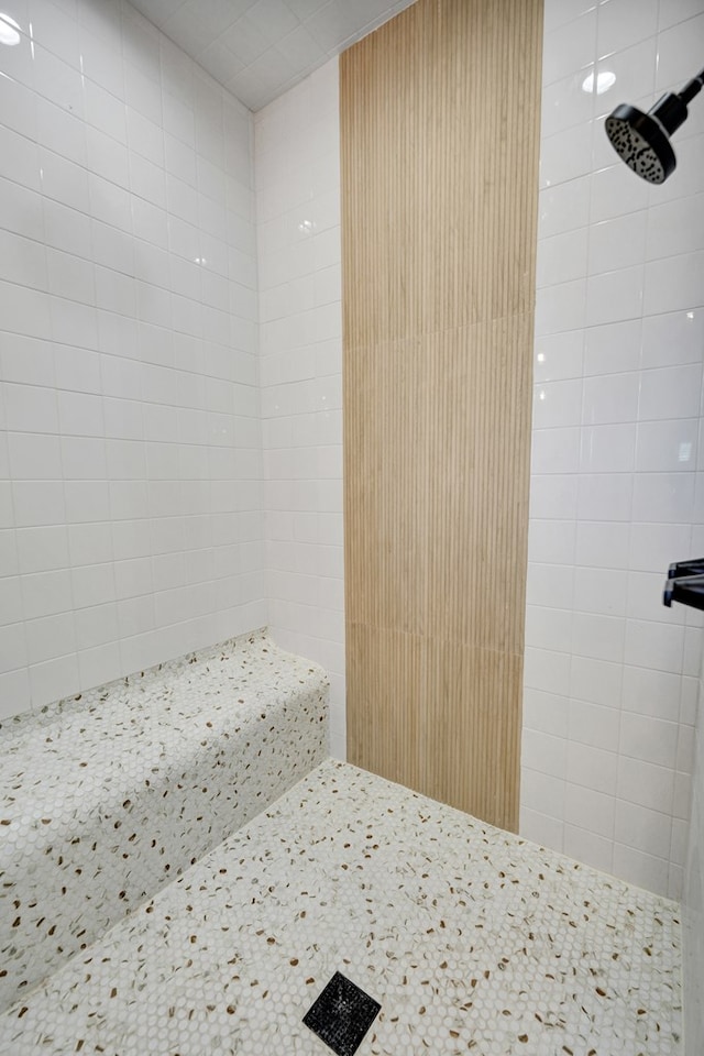 bathroom with a tile shower