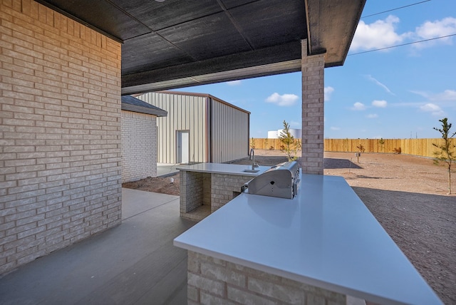 view of patio / terrace with an outdoor kitchen, a grill, and a bar