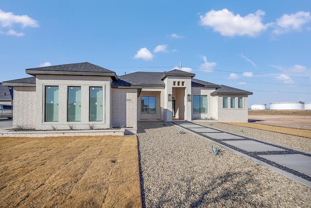 prairie-style home with a front yard