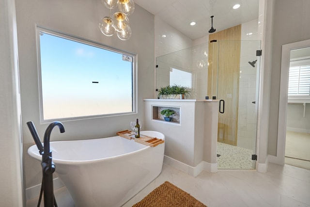 bathroom featuring independent shower and bath and a notable chandelier