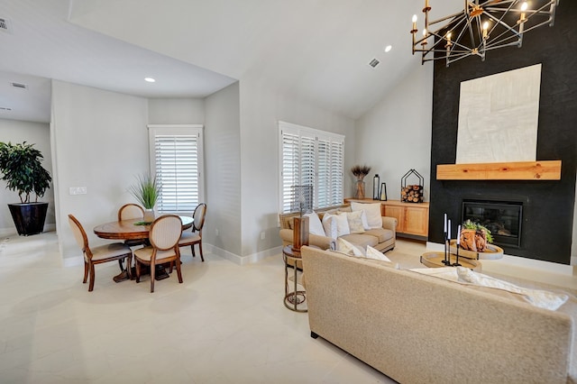 living room with a large fireplace, a notable chandelier, and high vaulted ceiling