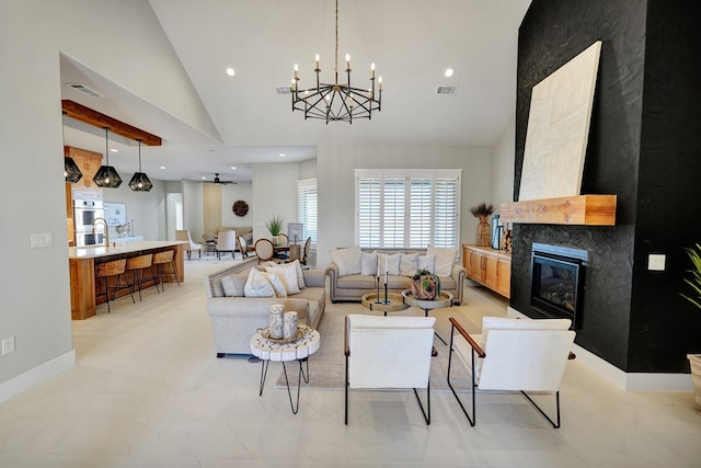 living room with a notable chandelier and high vaulted ceiling