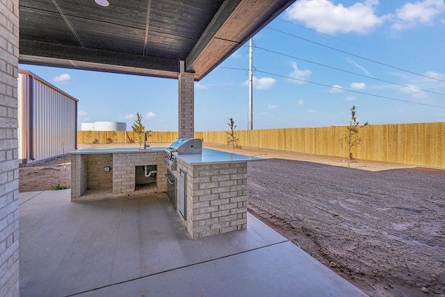 view of patio featuring a grill and exterior kitchen