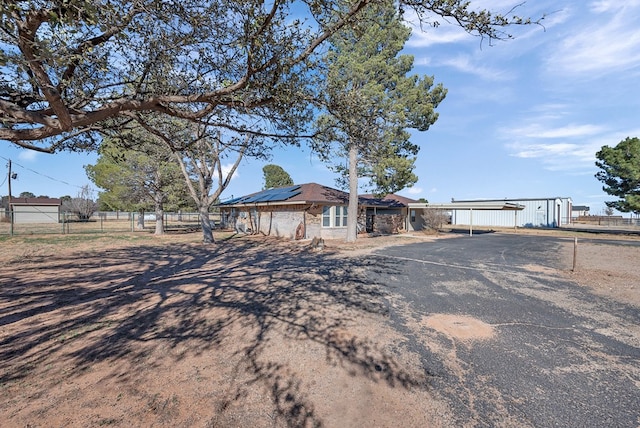 ranch-style home with solar panels