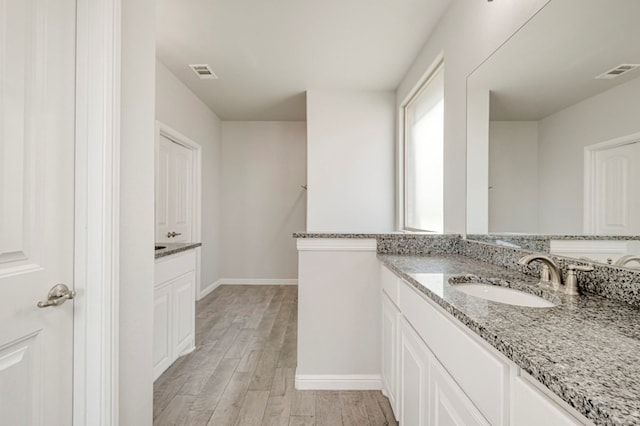 9 Senita Ct, Odessa, TX 79765 - full bath featuring vanity, wood finished floors, and baseboards