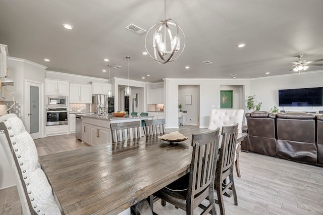 9 Senita Ct, Odessa, TX 79765 - dining room featuring ornamental molding, recessed lighting, a chandelier, light wood-type flooring, and ceiling fan