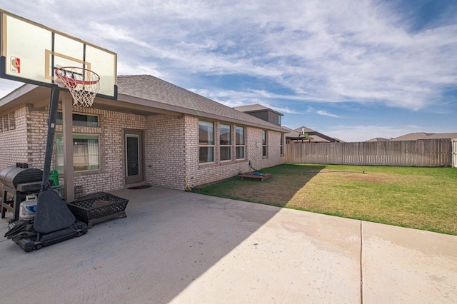 9 Senita Ct, Odessa, TX 79765 - back of property with brick siding, a patio area, and roof with shingles