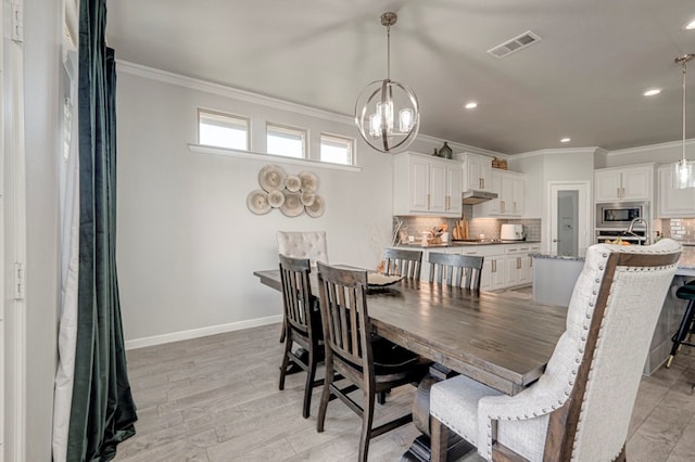 9 Senita Ct, Odessa, TX 79765 - dining area featuring crown molding, a chandelier, baseboards, recessed lighting, and light wood-style floors
