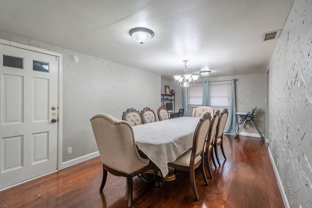 807 Boyd Ave, Midland, TX 79705 - dining room with dark wood-style flooring, visible vents, baseboards, a notable chandelier, and a textured wall