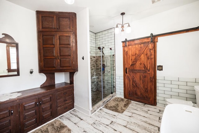 2306 32nd St, Snyder, TX 79549 - bathroom featuring an enclosed shower and tile walls
