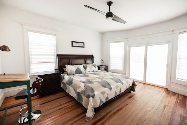 2306 32nd St, Snyder, TX 79549 - bedroom with ceiling fan, access to exterior, wood-type flooring, and multiple windows
