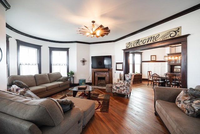 2306 32nd St, Snyder, TX 79549 - living room featuring ornamental molding, a chandelier, and wood-type flooring