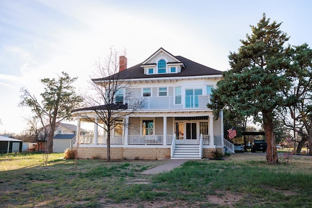 view of front of home featuring a front yard and a porch