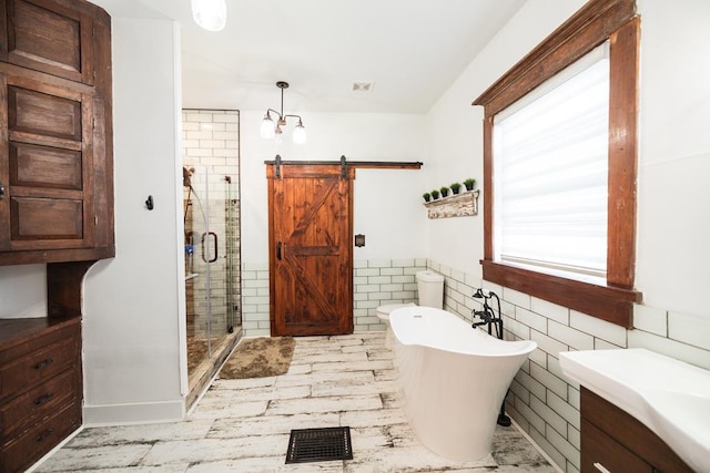 2306 32nd St, Snyder, TX 79549 - bathroom with vanity, tile walls, and shower with separate bathtub