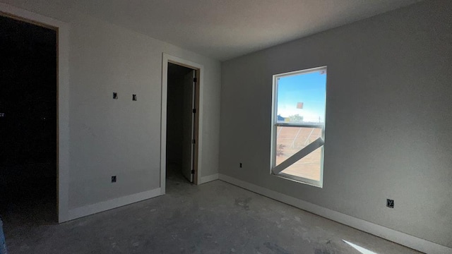 unfurnished room featuring concrete flooring