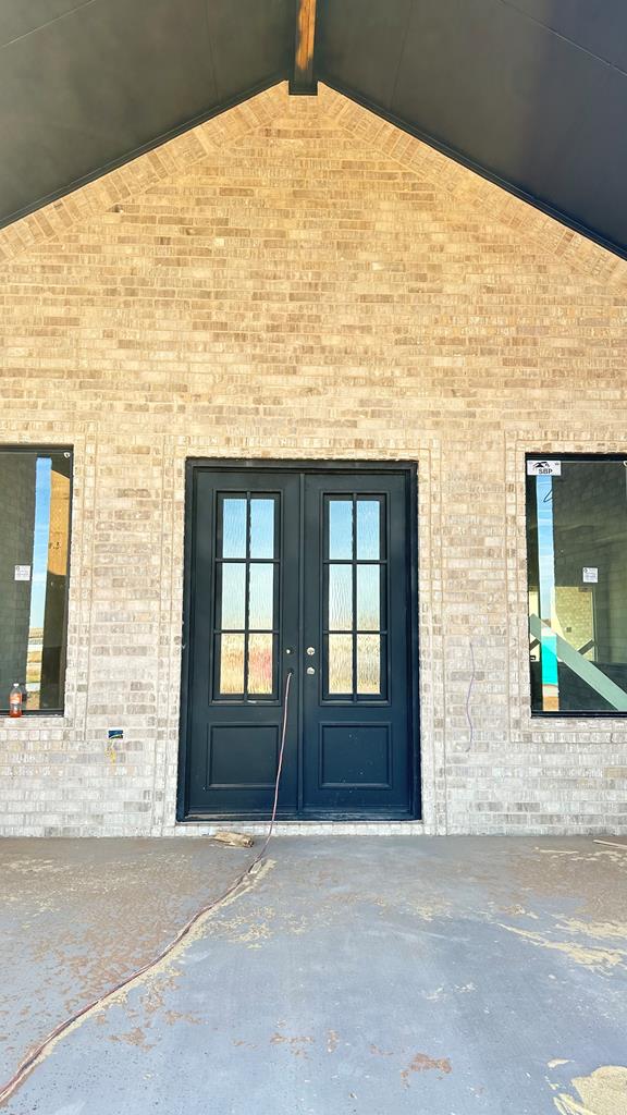 view of exterior entry featuring french doors