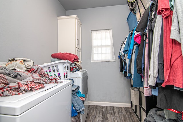 washroom featuring cabinets, dark hardwood / wood-style floors, and washer / clothes dryer