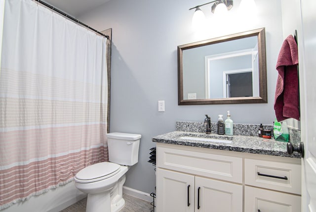 full bathroom with vanity, shower / bath combo, and toilet