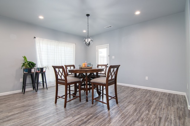 dining room featuring wood-type flooring and a chandelier