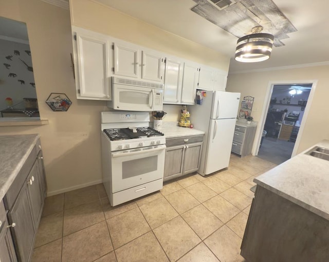 311 Kessler Ave, Midland, TX 79701 - kitchen with white appliances, ornamental molding, white cabinets, light tile patterned floors, and light countertops