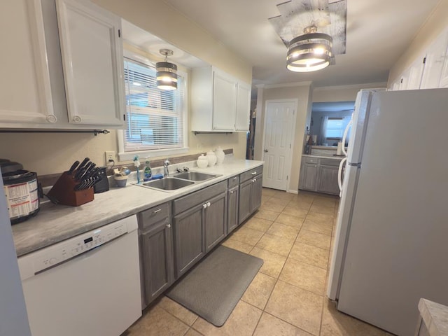 311 Kessler Ave, Midland, TX 79701 - kitchen featuring white appliances, a sink, light tile patterned floors, white cabinets, and light countertops