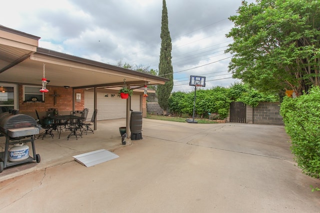view of patio featuring a detached garage and outdoor dining area