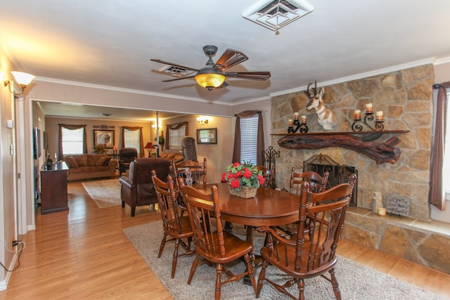 dining area with ceiling fan, visible vents, ornamental molding, and light wood finished floors