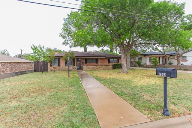 ranch-style home featuring a front lawn and a chimney