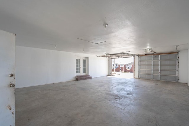 garage featuring french doors and a garage door opener
