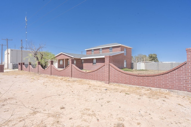 rear view of property with fence