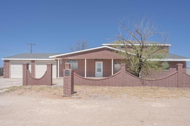 single story home featuring driveway, an attached garage, and brick siding