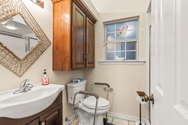4000 Baybrook Dr, Midland, TX 79707 - bathroom with toilet, baseboards, vanity, tile patterned flooring, and a shower
