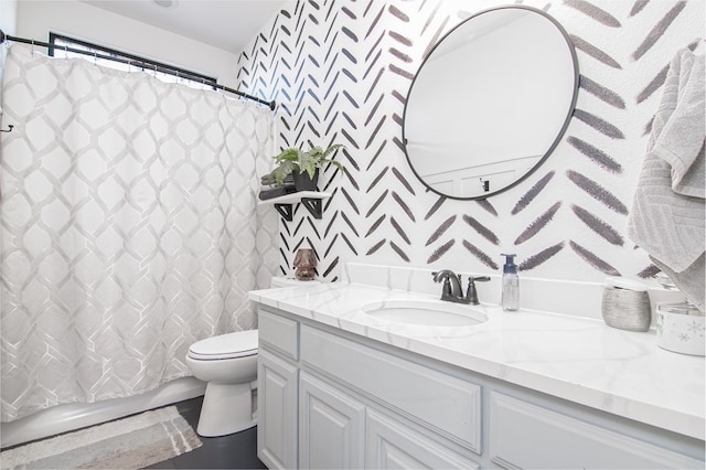 bathroom featuring toilet and vanity