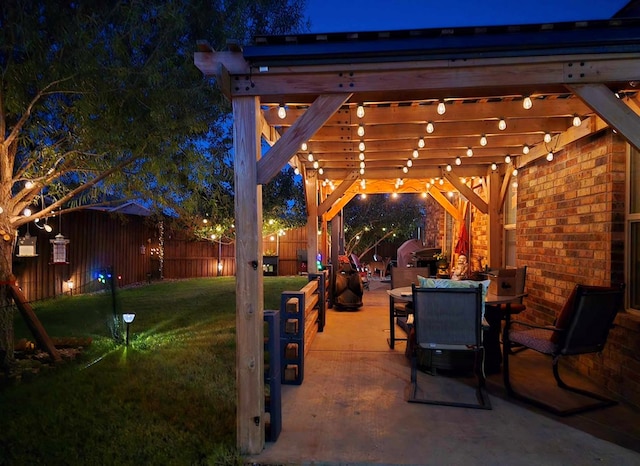 patio at twilight with a yard and a pergola