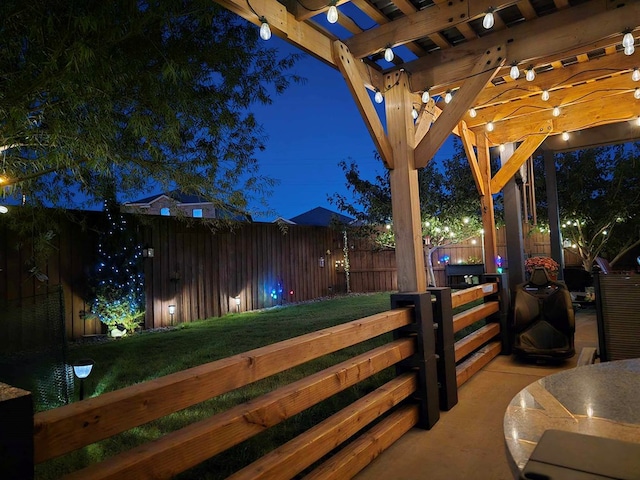 patio at twilight with a pergola and a yard