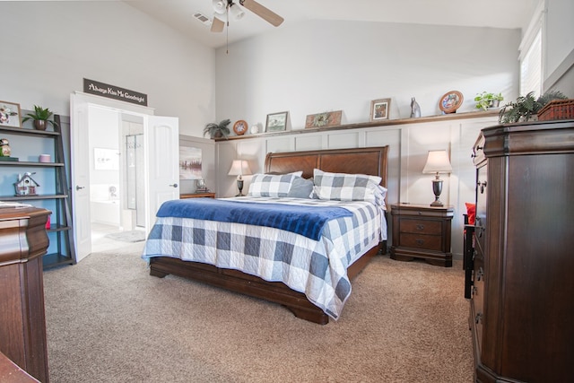 carpeted bedroom featuring ensuite bathroom, ceiling fan, and lofted ceiling