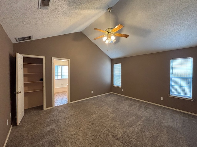 3507 Edgemont Dr, Midland, TX 79707 - unfurnished bedroom featuring lofted ceiling, carpet, a textured ceiling, a spacious closet, and baseboards