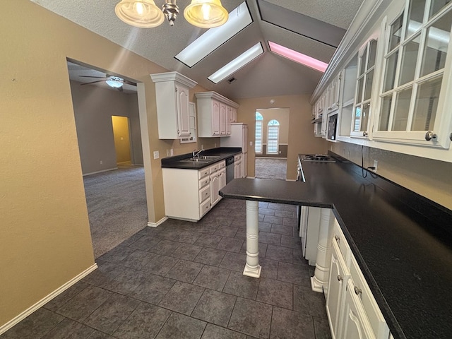 3507 Edgemont Dr, Midland, TX 79707 - kitchen with lofted ceiling, baseboards, dark countertops, ceiling fan, and dishwasher