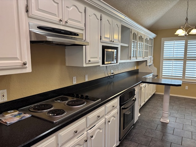 3507 Edgemont Dr, Midland, TX 79707 - kitchen featuring stainless steel appliances, under cabinet range hood, a chandelier, white cabinetry, and a textured ceiling