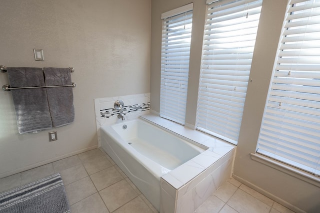 full bathroom featuring baseboards, a bath, and tile patterned floors