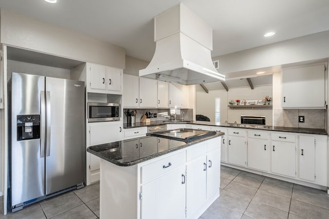 kitchen with stainless steel appliances, light tile patterned flooring, backsplash, and island range hood