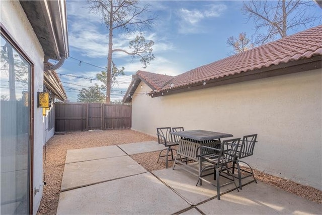 view of patio / terrace with outdoor dining space and fence